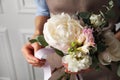 Florist creating beautiful bouquet at white wall, closeup Royalty Free Stock Photo