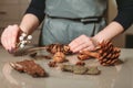 Florist creating christmas decoration closeup