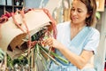 Florist decorates flower bouquet in shop closeup