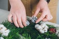 Florist decorator making Christmas wreath