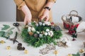 Florist decorator making Christmas wreath