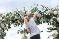 Florist girl decorationg wedding chuppa with flowers Royalty Free Stock Photo