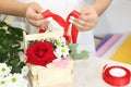 Florist girl working in a flower shop. Soft shades of fresh spring flowers, wrapped in decorative paper or placed in box. Floristr Royalty Free Stock Photo