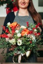 Florist hands holding bouquet flowers closeup.