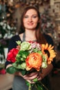 Florist hands holding bouquet flowers closeup.