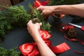 Florist hands making Christmas wreath
