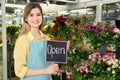 Florist holding sign with text OPEN