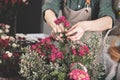 Florist make gift bouquets. Graceful female hands make a beautiful bouquet. Florist workplace. Small business concept