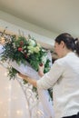 Florist make winter wedding floral arch composition indoors