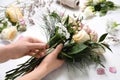 Florist making beautiful bouquet at white table, closeup Royalty Free Stock Photo