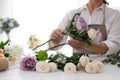 Florist making beautiful wedding bouquet at white table, closeup Royalty Free Stock Photo