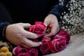 florist making bouquets of pink roses for valentine's day