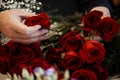 florist making bouquets of red roses for valentines day Royalty Free Stock Photo