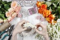 Florist making wicker wreath decorated with tiny daisies