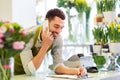 Florist man calling on smartphone at flower shop Royalty Free Stock Photo