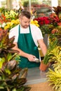 Florist man reading barcode potted plant shop