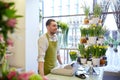 Florist man or seller at flower shop counter Royalty Free Stock Photo