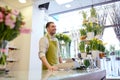 Florist man or seller at flower shop counter Royalty Free Stock Photo