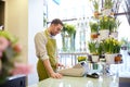 Florist man or seller at flower shop counter Royalty Free Stock Photo