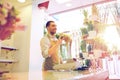 Florist man or seller at flower shop counter Royalty Free Stock Photo