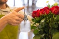 Florist or seller moistening roses at flower shop