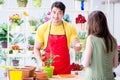 The florist selling flowers in a flower shop Royalty Free Stock Photo