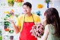 The florist selling flowers in a flower shop Royalty Free Stock Photo