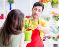 Florist selling flowers in a flower shop Royalty Free Stock Photo