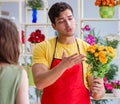 Florist selling flowers in a flower shop Royalty Free Stock Photo