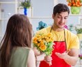 Florist selling flowers in a flower shop Royalty Free Stock Photo