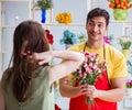 Florist selling flowers in a flower shop Royalty Free Stock Photo