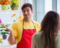 Florist selling flowers in a flower shop Royalty Free Stock Photo