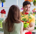 Florist selling flowers in a flower shop Royalty Free Stock Photo
