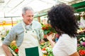 Florist selling flowers to a customer Royalty Free Stock Photo