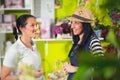 Florist serves female customer in buying flowers at store. Royalty Free Stock Photo