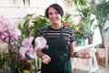 Florist smiling among plants