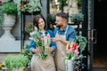 Florist teaches assistant to make bouquet for client online order