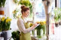 Florist woman with clipboard at flower shop