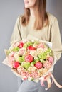 Florist woman creates beautiful bouquet of mixed flowers with varietal carnations, peony and eustoma. European floral Royalty Free Stock Photo