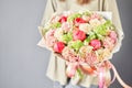 Florist woman creates beautiful bouquet of mixed flowers with varietal carnations, peony and eustoma. European floral Royalty Free Stock Photo