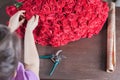 Florist woman prepares a big bouquet of red roses Royalty Free Stock Photo