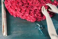 Florist woman prepares a big bouquet of red roses Royalty Free Stock Photo