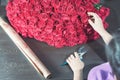 Florist woman prepares a big bouquet of red roses Royalty Free Stock Photo