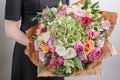 Florist at work. Make hydrangea rich bouquet. Vintage floristic background, colorful roses, antique scissors and a rope Royalty Free Stock Photo