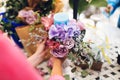 Florist at work, making a flower composition. Wedding details. Woman collecting a composition of different, colorful