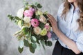 Florist at work: pretty young woman making fashion modern bouquet of different flowers Royalty Free Stock Photo