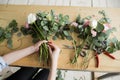 Florist at work: pretty young woman making fashion modern bouquet of different flowers Royalty Free Stock Photo