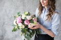 Florist at work: pretty young woman making fashion modern bouquet of different flowers Royalty Free Stock Photo