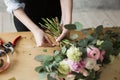 Florist at work: pretty young woman making fashion modern bouquet of different flowers Royalty Free Stock Photo