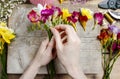 Florist at work. Woman making bouquet of freesia flowers